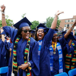 Howard University students celebrating at graduation.